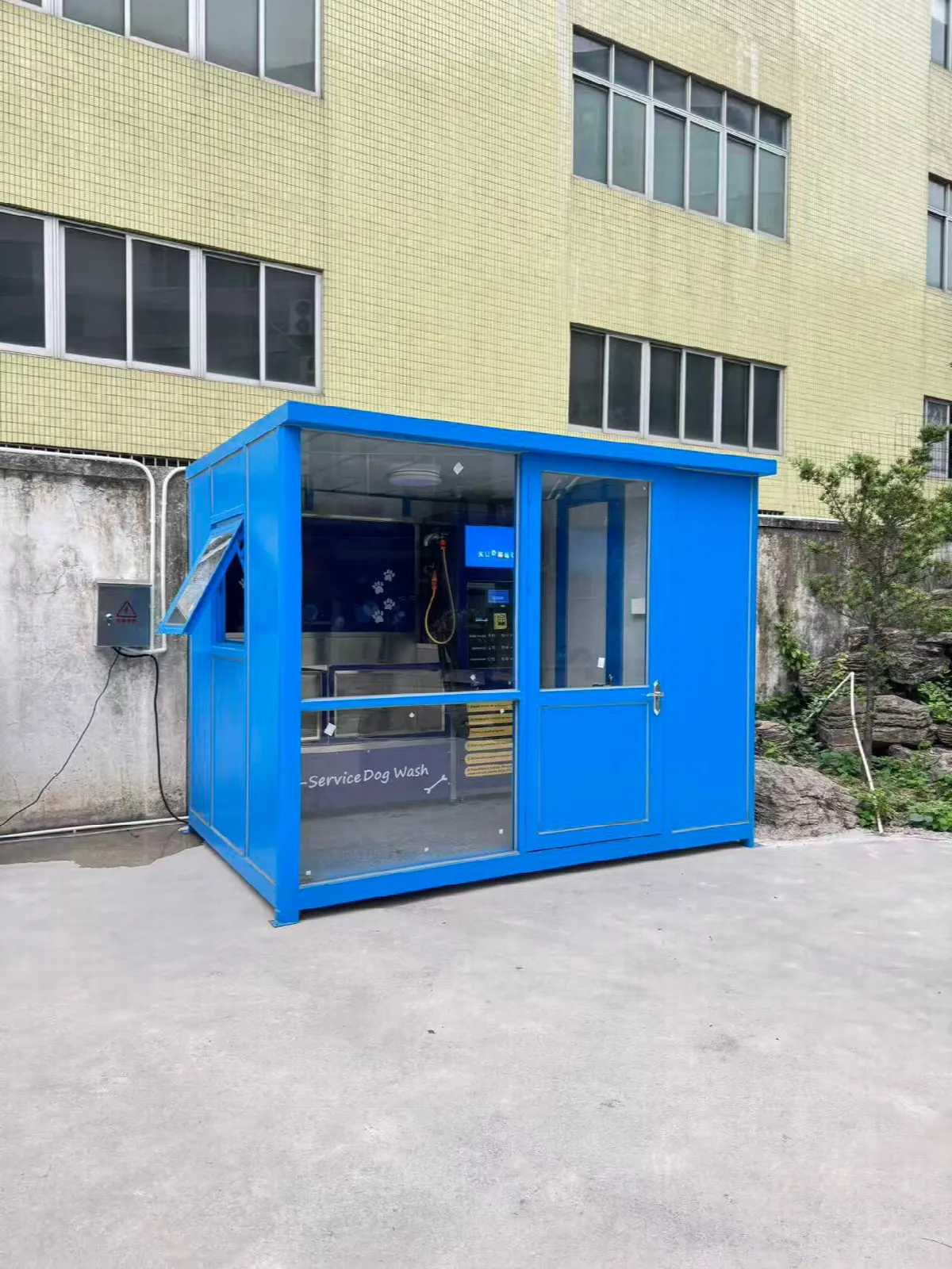 Completed outdoor self-service dog wash cabin outside the workshop